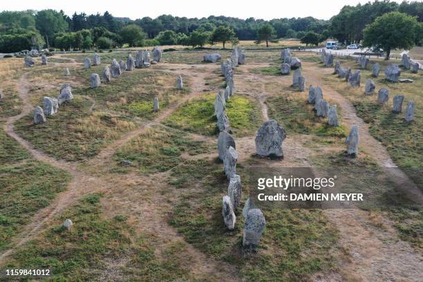 This aerial picture taken on August 4, 2019 shows the Carnac standing stones, a collection of Neolithic stones at a site in the city of Carnac,...