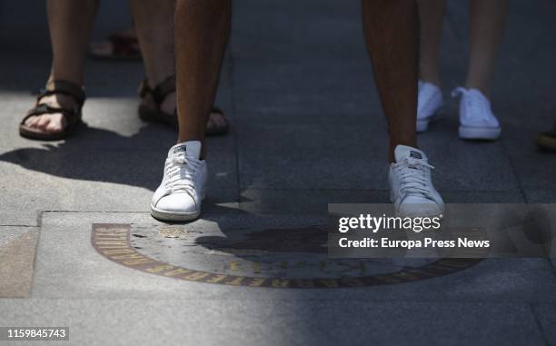 People stand at 'Kilómetro Cero' point at Puerta del Sol on July 03, 2019 in Madrid, Spain.