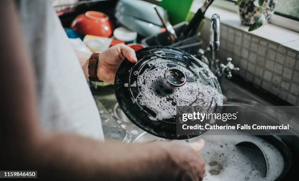 washing dishes - cast iron stock pictures, royalty-free photos & images