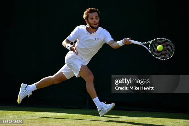 Corentin Moutet of France plays a forehand in his Men's Singles second round match against Felix Auger-Aliassime of Canada during Day three of The...