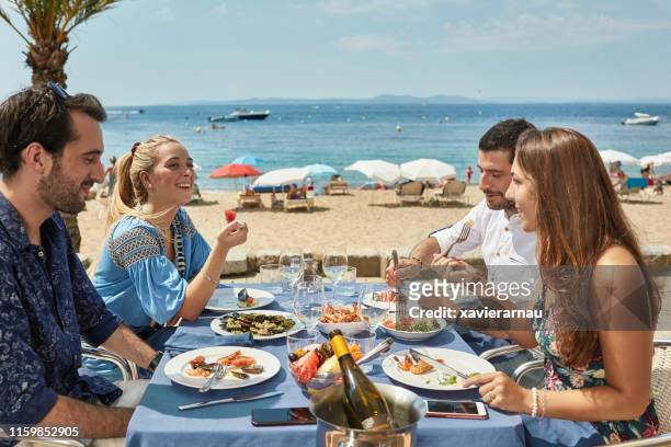 amis appréciant des fruits de mer et du vin au restaurant de costa brava - province de gérone photos et images de collection