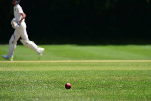 cricket ball with cricket batsman running - cricket game stock pictures, royalty-free photos & images