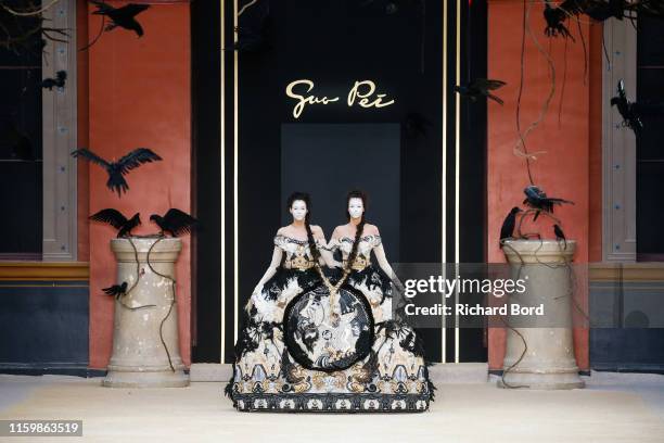 Models walk the runway during the Guo Pei Fall/Winter 2019 2020 show at 'Ecole des Beaux Arts' as part of Paris Fashion Week on July 03, 2019 in...