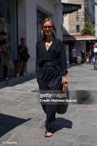 Guest is seen on the street during Paris Fashion Week Haute Couture wearing black outfit with black belt and bag on July 03, 2019 in Paris, France.