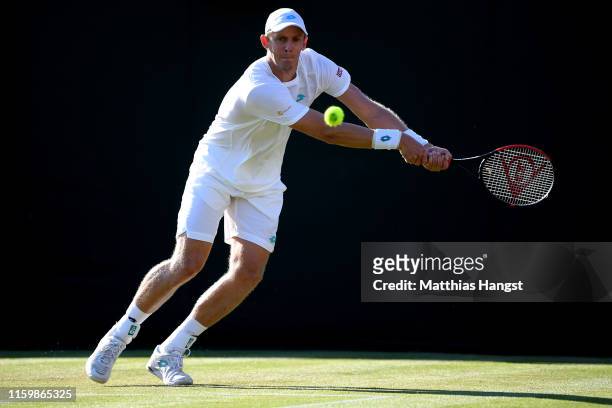 Kevin Anderson of South Africa plays a backhand in his Men's Singles second round match against Janko Tipsarevic of Serbia during Day three of The...