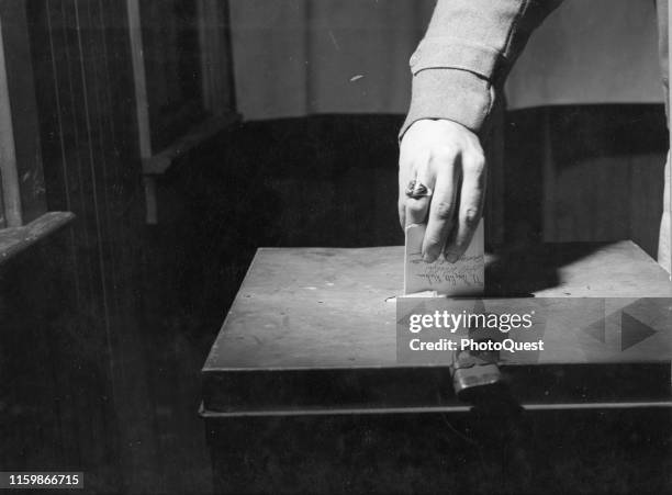 Close-up of a hand as it inserts a ballot into a box during the US Presidential election, Lancaster, Pennsylvania, November 2, 1948.