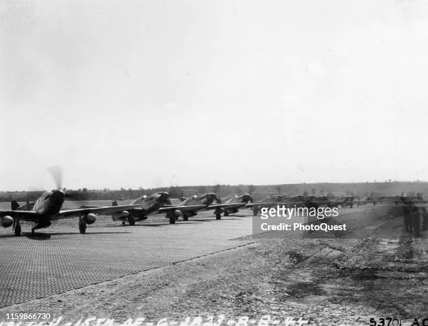 View of a line of the 332nd Fighter Group, 15th Army Air Force's North American P-51 Mustangs as they warm up on the line at Ramitelli Airfield,...
