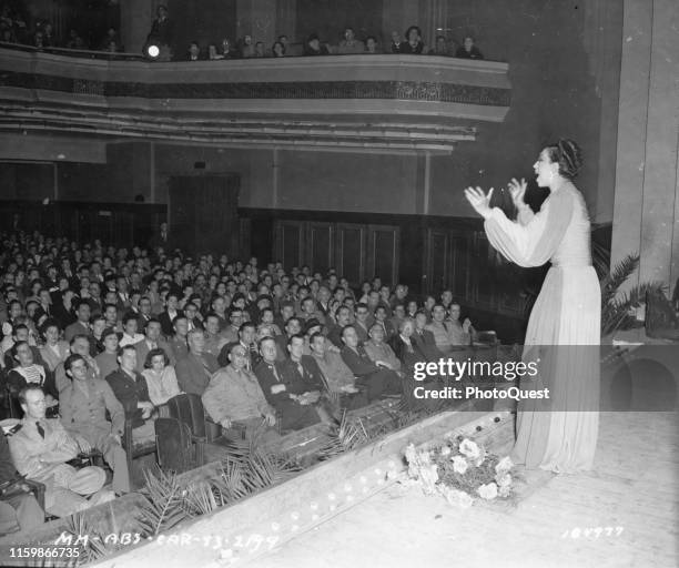 American-born French singer, activist, and member of the French Resistance Josephine Baker performs onstage for an audience that includes a number of...