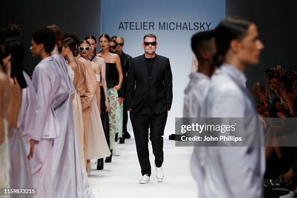 Designer Michael Michalsky and models acknowledge the applause of the audience after the Atelier Michalsky show during the Berlin Fashion Week...