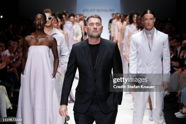 Designer Michael Michalsky and models acknowledge the applause of the audience after the Atelier Michalsky show during the Berlin Fashion Week...