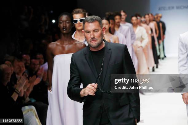 Designer Michael Michalsky and models acknowledge the applause of the audience after the Atelier Michalsky show during the Berlin Fashion Week...