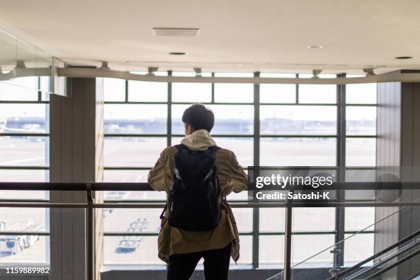 teenage boy waiting for departure at airport - japan tourism stock pictures, royalty-free photos & images