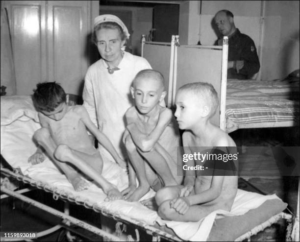 Nurse at the Robert Kooh hospital in Berlin exhibits in October 1945 three German children evicted from a Polish orphanage in Danzig . Many German...