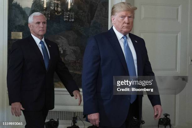 President Donald Trump, right, and U.S. Vice President Mike Pence arrive to speak at the White House in Washington, D.C., U.S., on Monday, Aug. 5,...