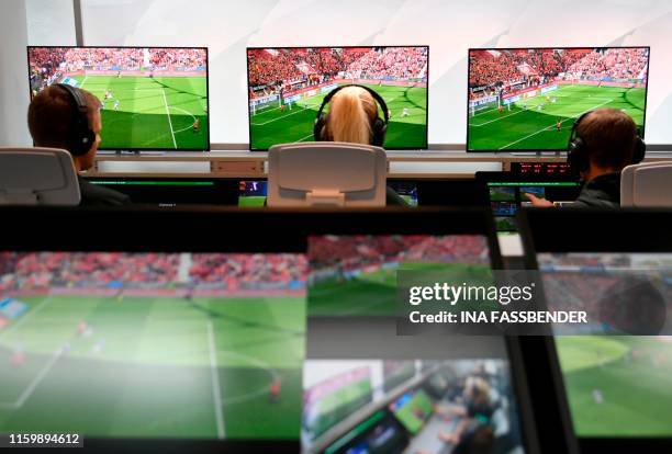 Bundesliga Referee Bibiana Steinhaus and referee Thorben Siewer sit at the Video Assist Center during the Media Workshop "Video Assistant" at the...