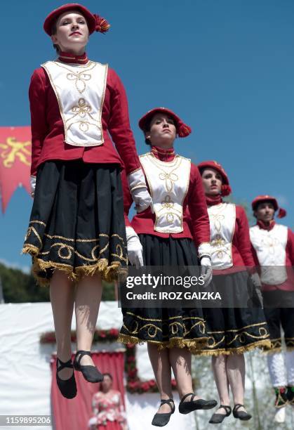 Dancers perform on stage, during the pastoral , a traditional play from the Basque Country in the region of Soule, in Pagolle, on July 28, 2019.