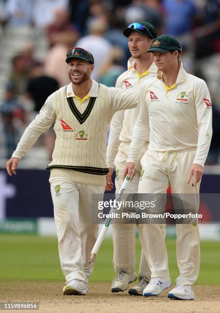 David Warner, Cameron Bancroft and Steve Smith of Australia leave the field after Australia won the first Specsavers Test Match between England and...