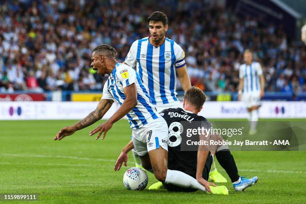 Juninho Bacuna of Huddersfield Town wins a penalty under a tackle from Kieran Dowell of Derby Count during the Sky Bet Championship match between...