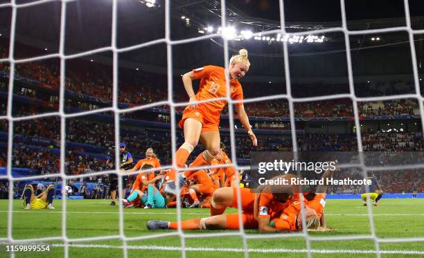 Netherlands players celebrate following their sides victory in the 2019 FIFA Women's World Cup France Semi Final match between Netherlands and Sweden...