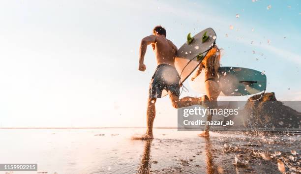 adventures are better enjoyed together. - couple running on beach stock pictures, royalty-free photos & images