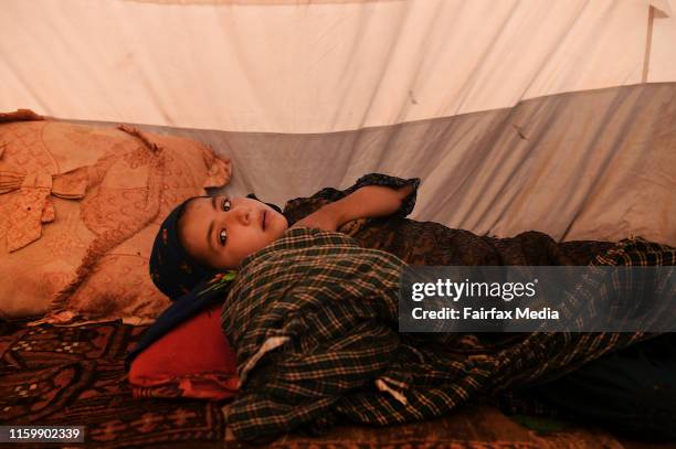 Four-year-old Khadija lies in her family’s temporary shelter in the Regreshan IDP camp in Herat Province, Afghanistan, June 17, 2019. Her father,...