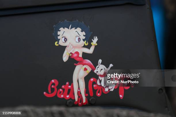 An image of Betty Boop, an animated cartoon character, seen on a WW2 Jeep during the Parade of Liberation in the streets of Granville, a part of many...