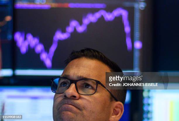 Traders work on the floor at the New York Stock Exchange on August 5, 2019 at Wall Street in New York City. - Wall Street stocks plunged after a...