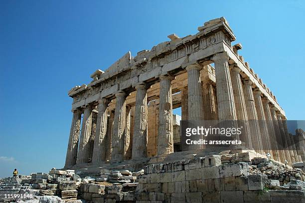ruins of the parthenon in greece against a blue sky - ancient greece stock pictures, royalty-free photos & images