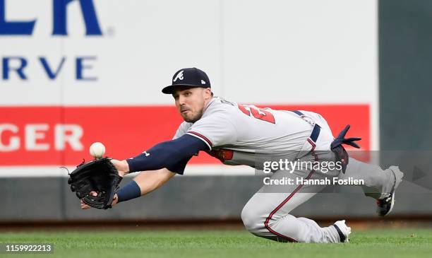 Adam Duvall of the Atlanta Braves makes a catch in left field of the ball hit by Marwin Gonzalez of the Minnesota Twins during the second inning of...