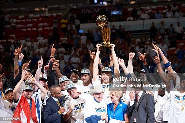 Finals: Dallas Mavericks Dirk Nowitzki victorious holding Larry O'Brien Championship trophy with teammates after winning Game 6 and championship...
