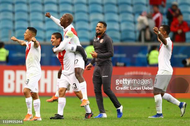 Luis Advincula and Aldo Corzo of Peru celebrate after winning the Copa America Brazil 2019 Semi Final match between Chile and Peru at Arena do Gremio...