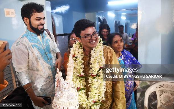 This photo taken on August 5, 2019 shows transgender man Dipan Chakraborty smiling as he arrives for his wedding to a transgender woman in Kolkata. -...