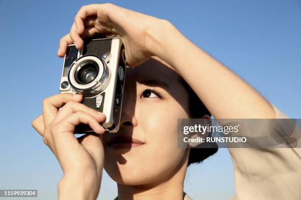close up of woman taking photos - japanese photographer stock pictures, royalty-free photos & images