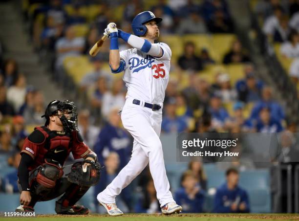 Cody Bellinger of the Los Angeles Dodgers hits a walk off solo homerun in front of Carson Kelly of the Arizona Diamondbacks, for a 5-4 win, during...