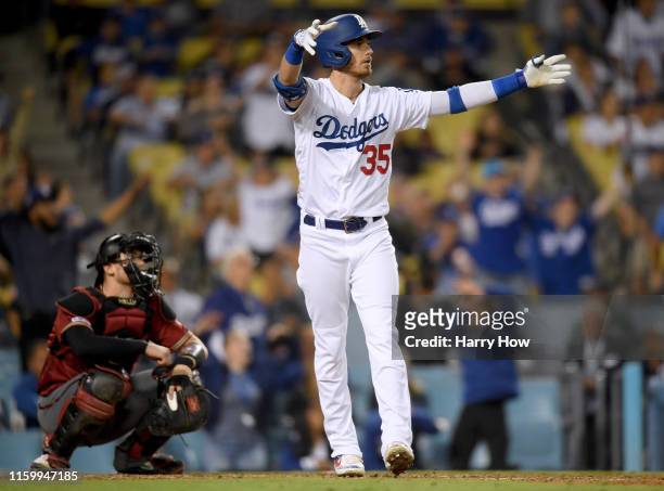 Cody Bellinger of the Los Angeles Dodgers reacts to his walk off solo homerun in front of Carson Kelly of the Arizona Diamondbacks, for a 5-4 win,...