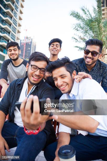 mobile connection, woman friends interacting on social media - emirati youth stock pictures, royalty-free photos & images
