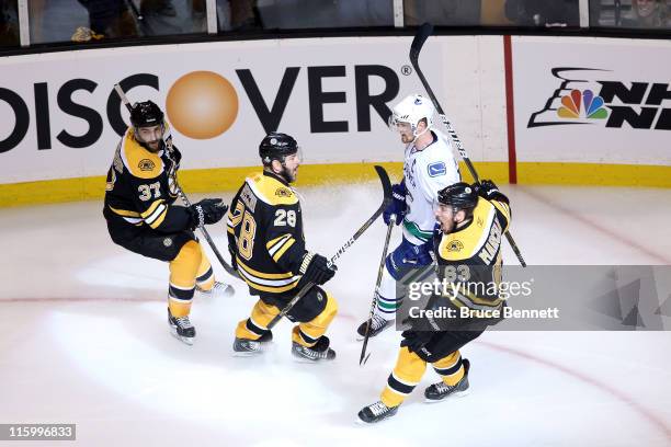 Brad Marchand of the Boston Bruins celebrates with Mark Recchi and Patrice Bergeron after scoring a goal in the first period against Roberto Luongo...