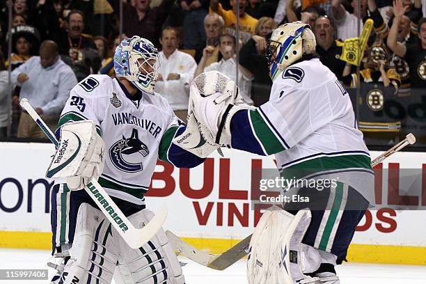 Cory Schneider of the Vancouver Canucks greets Roberto Luongo after replacing him in the first period during Game Six of the 2011 NHL Stanley Cup...