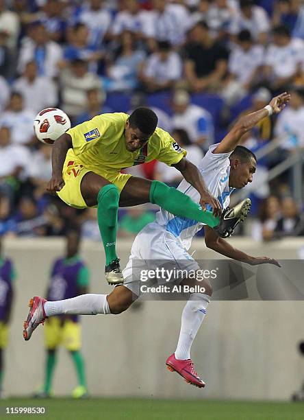 Cristian Noriega of Guatemala crashes into Shalrie Joseph Grenada during the Concaf Gold Cup at Red Bull Arena on June 13, 2011 in Harrison, New...