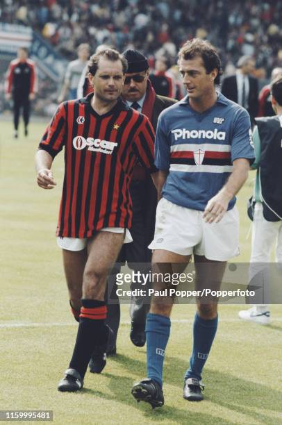 English footballers Ray Wilkins of AC Milan and Trevor Francis of Sampdoria pictured chatting together on the pitch after playing in the Serie A...