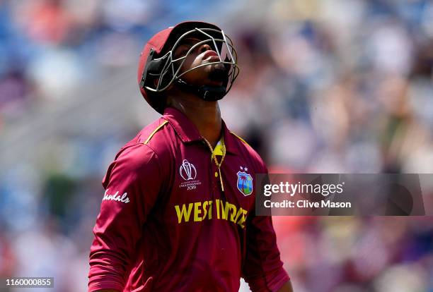 Shimron Hetmyer of West Indies walks off after being dismissed off the bowling of Dawlat Zadran of Afghanistan during the Group Stage match of the...
