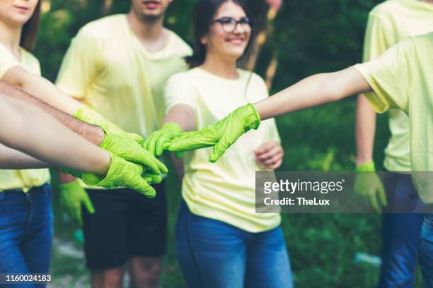 one for all and all for one - green glove stock pictures, royalty-free photos & images