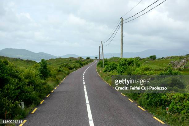 winding road near castletownbere, county cork, ireland - empty road stock-fotos und bilder