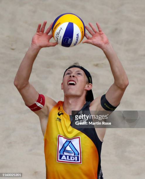 Philipp Bergmann of Germany in action against Anders Mol of Norway and Christian Sorum during the match on day seven of the FIVB Beach Volleyball...