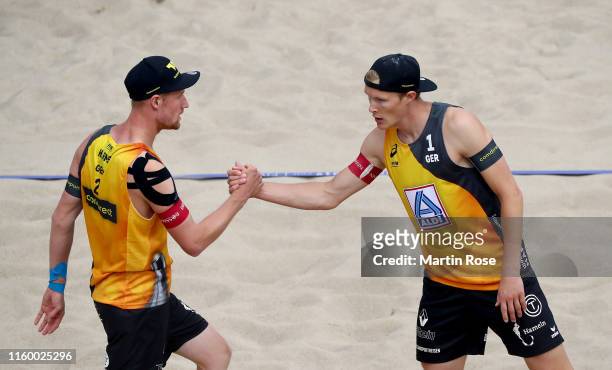 Philipp Bergmann and Yannick Harms of Germany look on against Anders Mol of Norway and Christian Sorum during the match on day seven of the FIVB...