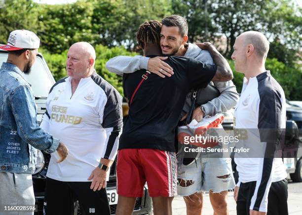 Joselu of Newcastle United hugs Rolando Aarons as they return to Pre-Season Training during the Newcastle United Training Session at the Newcastle...
