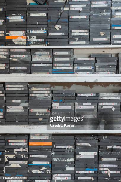 a pile of vhs tapes, vapourware, old junk, useless stuff - forsaken film stockfoto's en -beelden