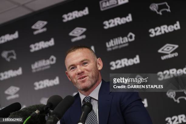 United midfielder and former England captain Wayne Rooney speaks during a press conference at Pride Park Stadium in Derby on August 6, 2019 after...