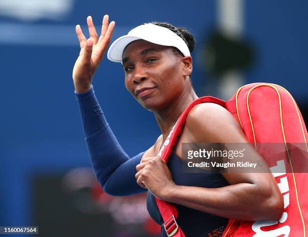 Venus Williams of the United States waves to the crowd after losing to Carla Suarez Navarro of Spain following a first round match on Day 4 of the...