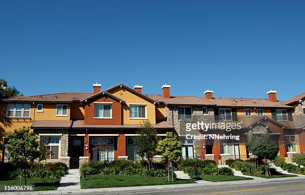 townhouses against clear blue sky - suburban apartments stock pictures, royalty-free photos & images